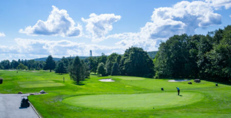 Photo of Picatinny Arsenal Golf Course on a sunny day with blue skys. Lots of greenery and trees can be seen in background.