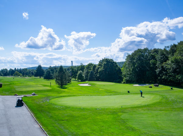 Photo of Picatinny Arsenal Golf Course on a sunny day with blue skys. Lots of greenery and trees can be seen in background.